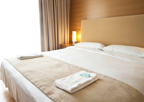 Two hotel bed linens on a bed